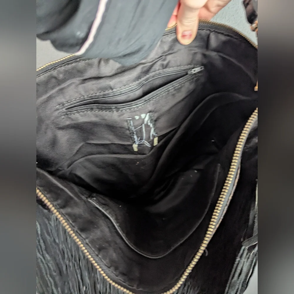Black leather Fringe crossbody bag feels like cow leather. No tags. No brand tag
